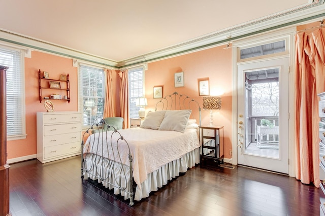 bedroom with access to exterior, ornamental molding, and dark wood-type flooring