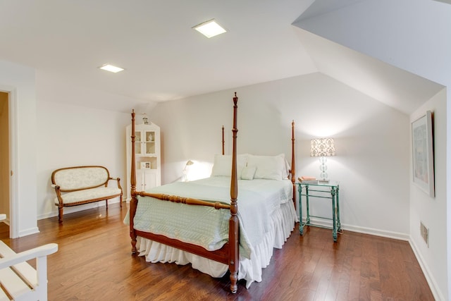 bedroom with lofted ceiling and wood-type flooring