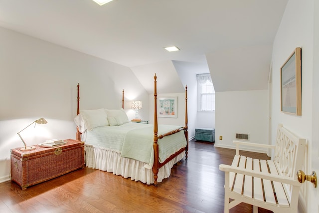 bedroom with lofted ceiling and wood-type flooring