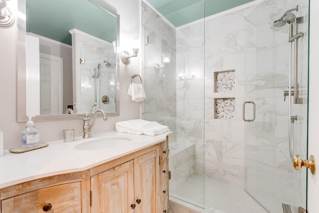 bathroom featuring vanity and a shower with door