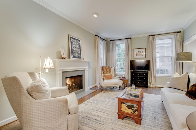 living room featuring hardwood / wood-style flooring, plenty of natural light, and ornamental molding