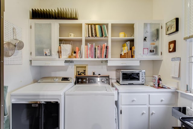 washroom with washing machine and clothes dryer