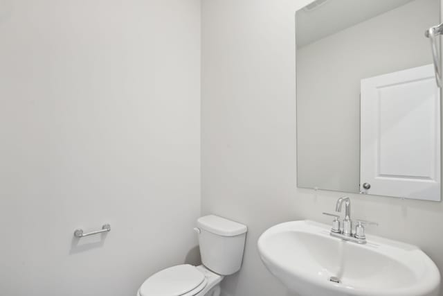 bathroom featuring toilet and a sink