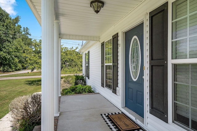 entrance to property with a lawn