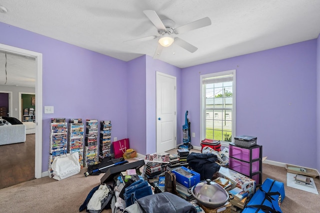 game room with ceiling fan, carpet, and a textured ceiling