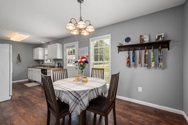 dining space featuring dark hardwood / wood-style flooring and a notable chandelier