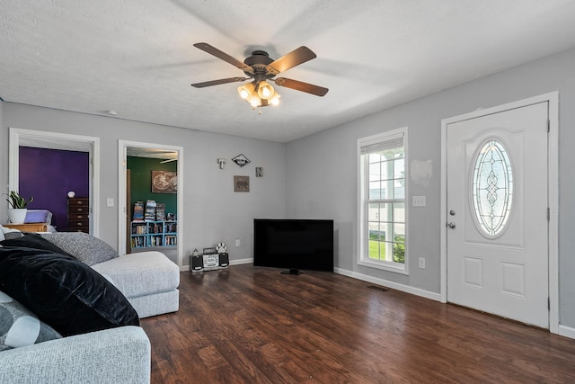 entrance foyer with ceiling fan, dark hardwood / wood-style flooring, and a textured ceiling