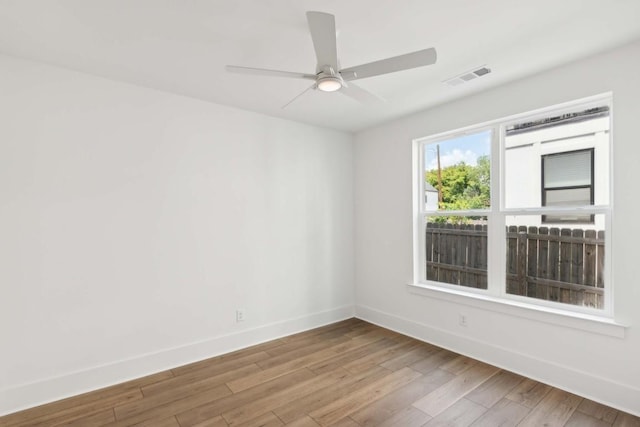 unfurnished room with hardwood / wood-style flooring and ceiling fan