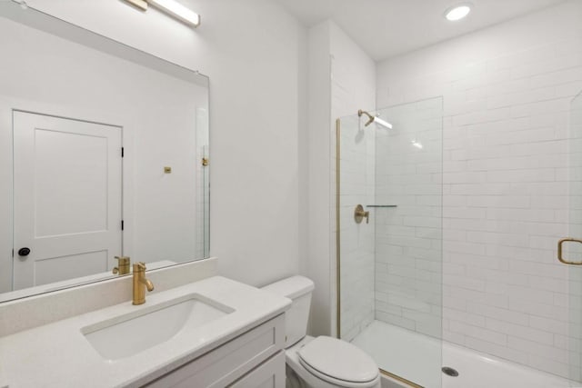 bathroom with vanity, an enclosed shower, and toilet