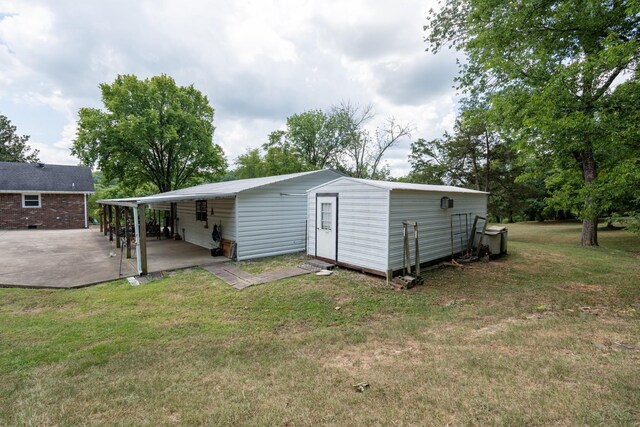 exterior space with a carport and a lawn