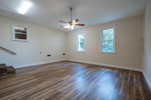 unfurnished room featuring ceiling fan and dark wood-type flooring