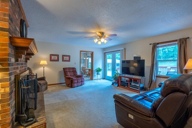 carpeted living room featuring ceiling fan, a fireplace, and a textured ceiling