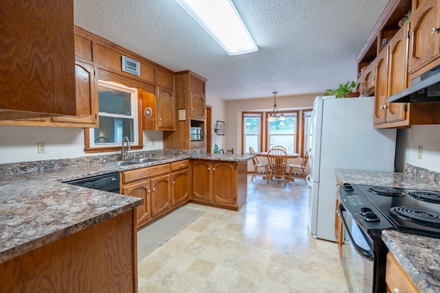 kitchen featuring pendant lighting, black appliances, sink, a textured ceiling, and kitchen peninsula