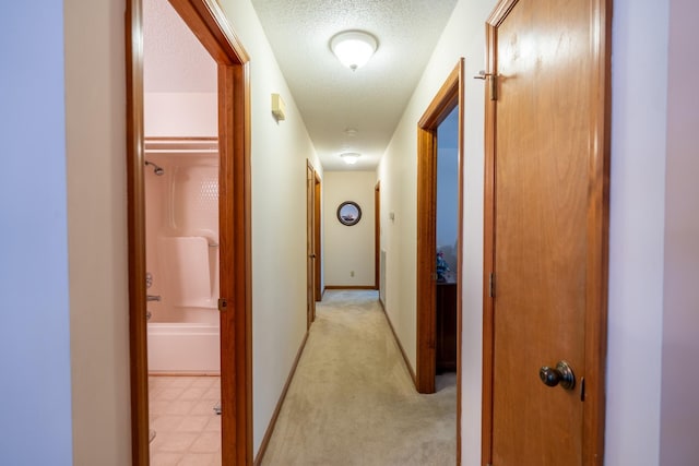 hallway with a textured ceiling