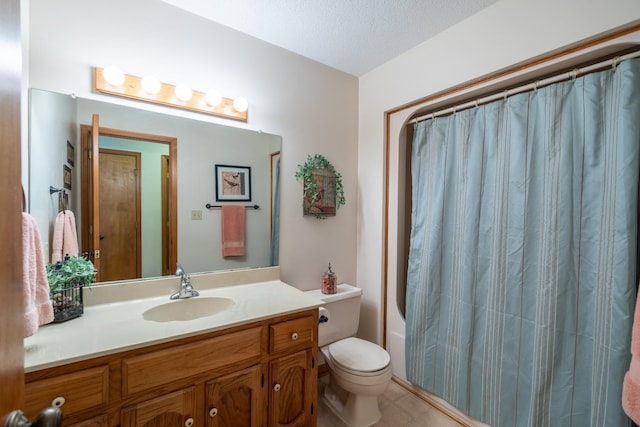 full bathroom with tile patterned flooring, a textured ceiling, toilet, shower / bath combo with shower curtain, and vanity