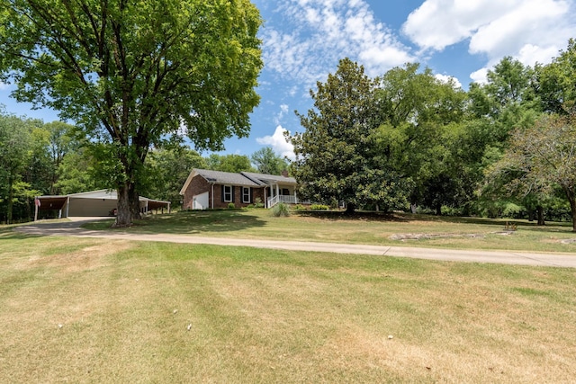 view of front of house with a front lawn and a carport