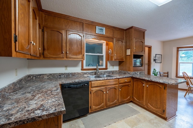 kitchen with a textured ceiling, sink, kitchen peninsula, and black dishwasher