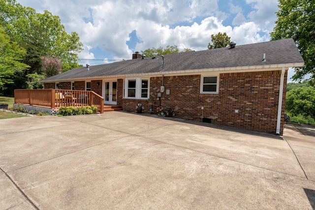 view of front of home featuring french doors and a wooden deck