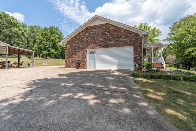 view of side of property featuring a yard and covered porch