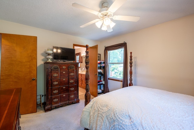 carpeted bedroom with ceiling fan and a textured ceiling