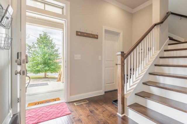 entryway featuring crown molding and dark hardwood / wood-style flooring