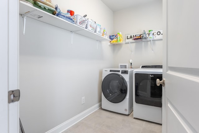 laundry room with separate washer and dryer and light tile patterned flooring