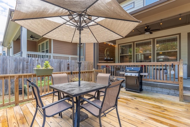 wooden deck featuring area for grilling and ceiling fan