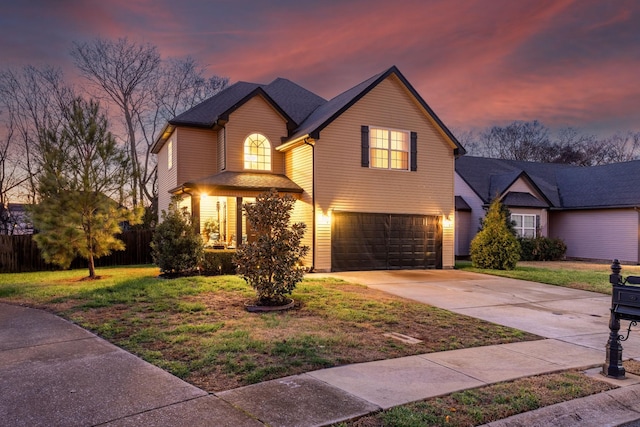 view of property featuring a garage and a yard