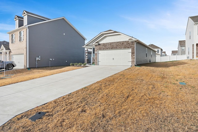 view of side of home featuring a lawn and a garage