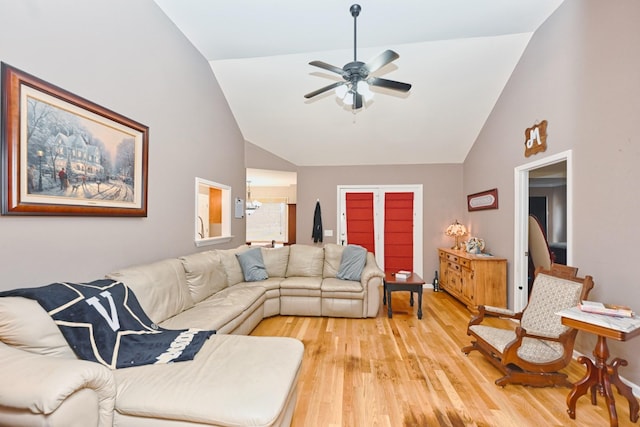 living room featuring high vaulted ceiling, light hardwood / wood-style flooring, and ceiling fan