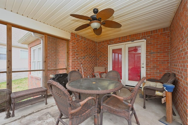 sunroom with ceiling fan and wood ceiling