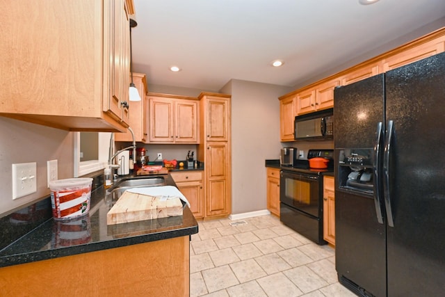 kitchen with light brown cabinetry, sink, and black appliances