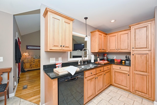 kitchen featuring pendant lighting, sink, vaulted ceiling, black dishwasher, and light hardwood / wood-style floors