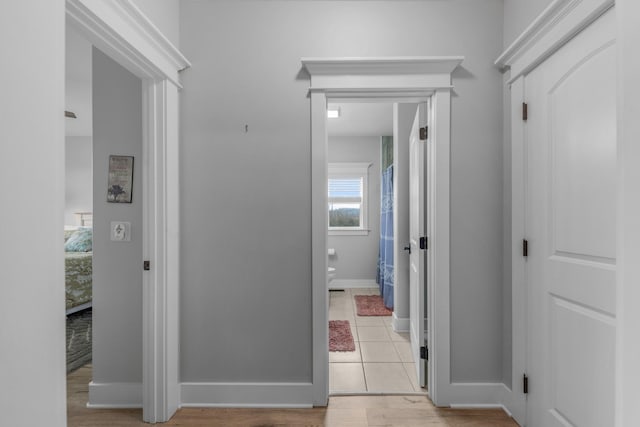 corridor with light hardwood / wood-style floors