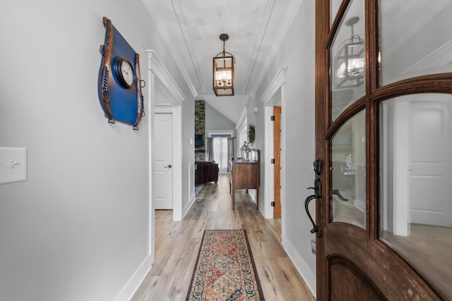 hallway with light hardwood / wood-style flooring and ornamental molding