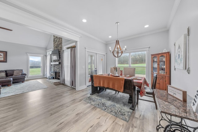 dining room featuring a chandelier, light wood-type flooring, and crown molding