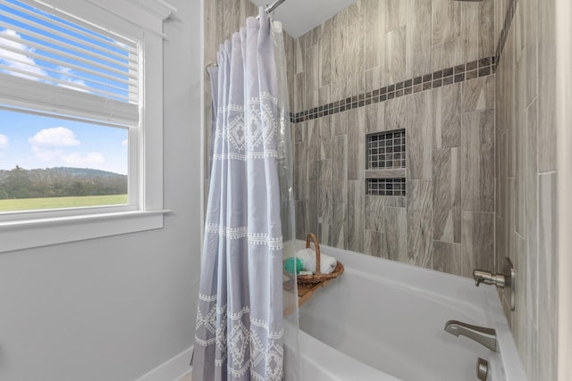 bathroom with shower / bathtub combination with curtain and a healthy amount of sunlight