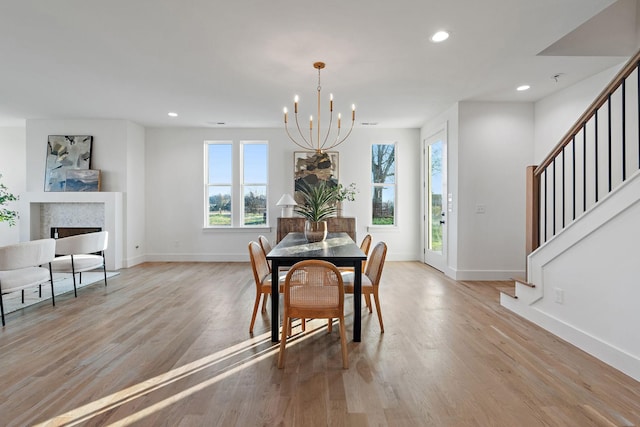 dining area featuring a chandelier, light hardwood / wood-style floors, and a wealth of natural light