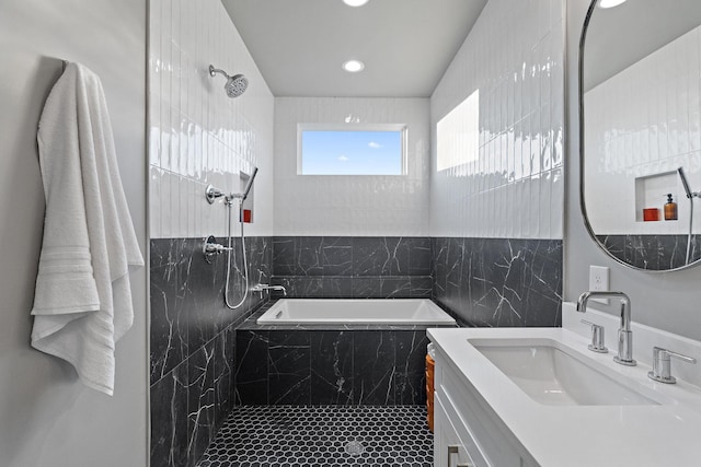 bathroom featuring tile walls, separate shower and tub, and vanity