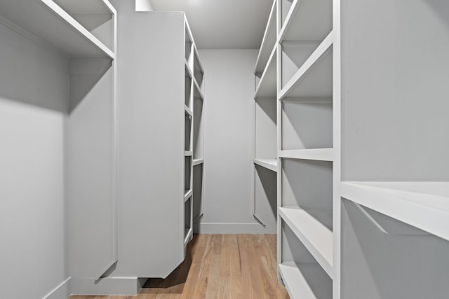 spacious closet featuring hardwood / wood-style flooring