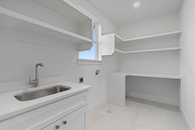 clothes washing area with hookup for a washing machine, cabinets, hookup for an electric dryer, and sink