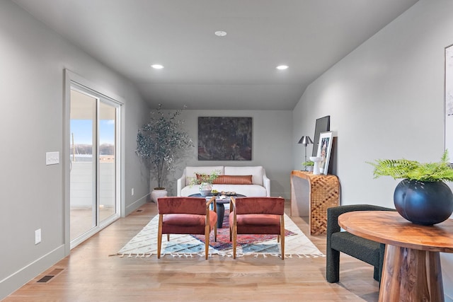 bedroom featuring light wood-type flooring, vaulted ceiling, and access to exterior