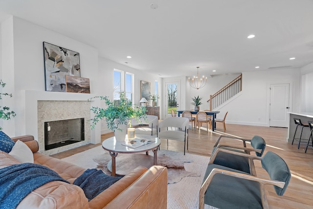 living room with a chandelier and light hardwood / wood-style floors