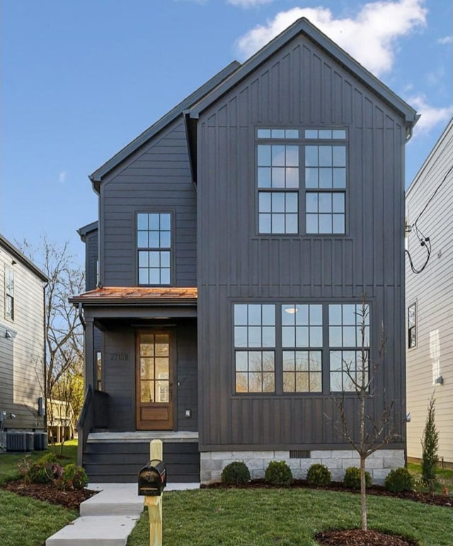 modern inspired farmhouse featuring a front yard and central AC