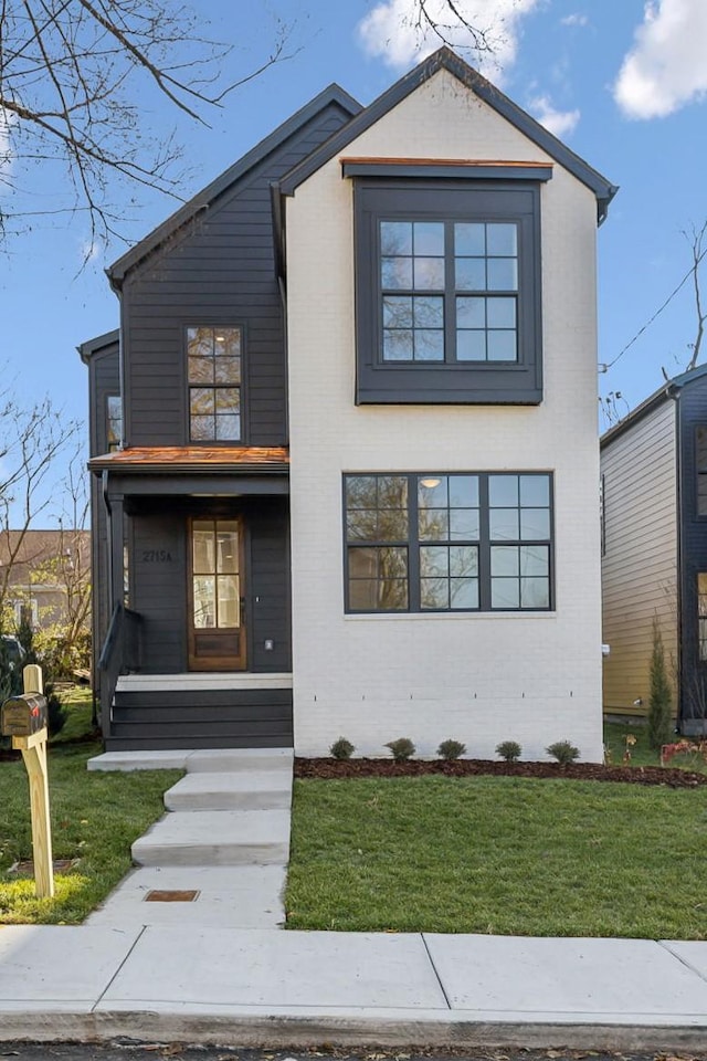 modern home featuring a front lawn