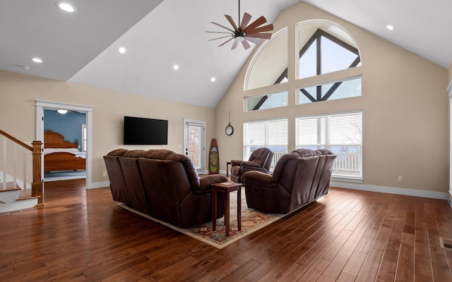 living room with ceiling fan, dark wood-type flooring, and high vaulted ceiling