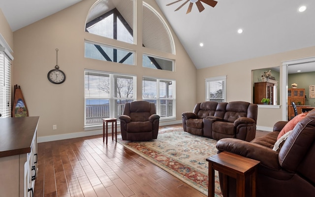 living room featuring hardwood / wood-style floors, high vaulted ceiling, and ceiling fan