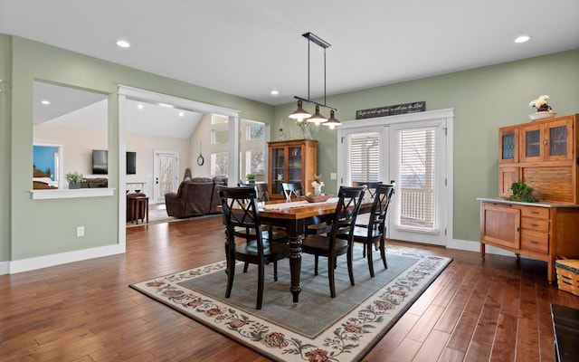 dining area featuring dark hardwood / wood-style flooring and lofted ceiling