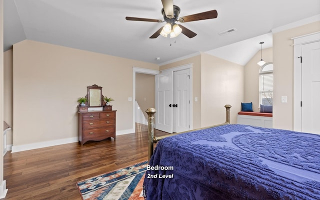 bedroom with vaulted ceiling, ceiling fan, and dark wood-type flooring