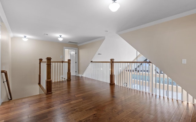 additional living space with hardwood / wood-style flooring